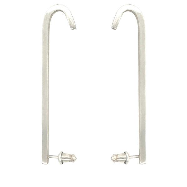 Image shows 2 upside down J shaped earrings made out of sterling silver and that has a matte brushed finish. Bullet style earring backs for added support. The Ear bars are made out of square wire, which gives this earring 4 flat sides.