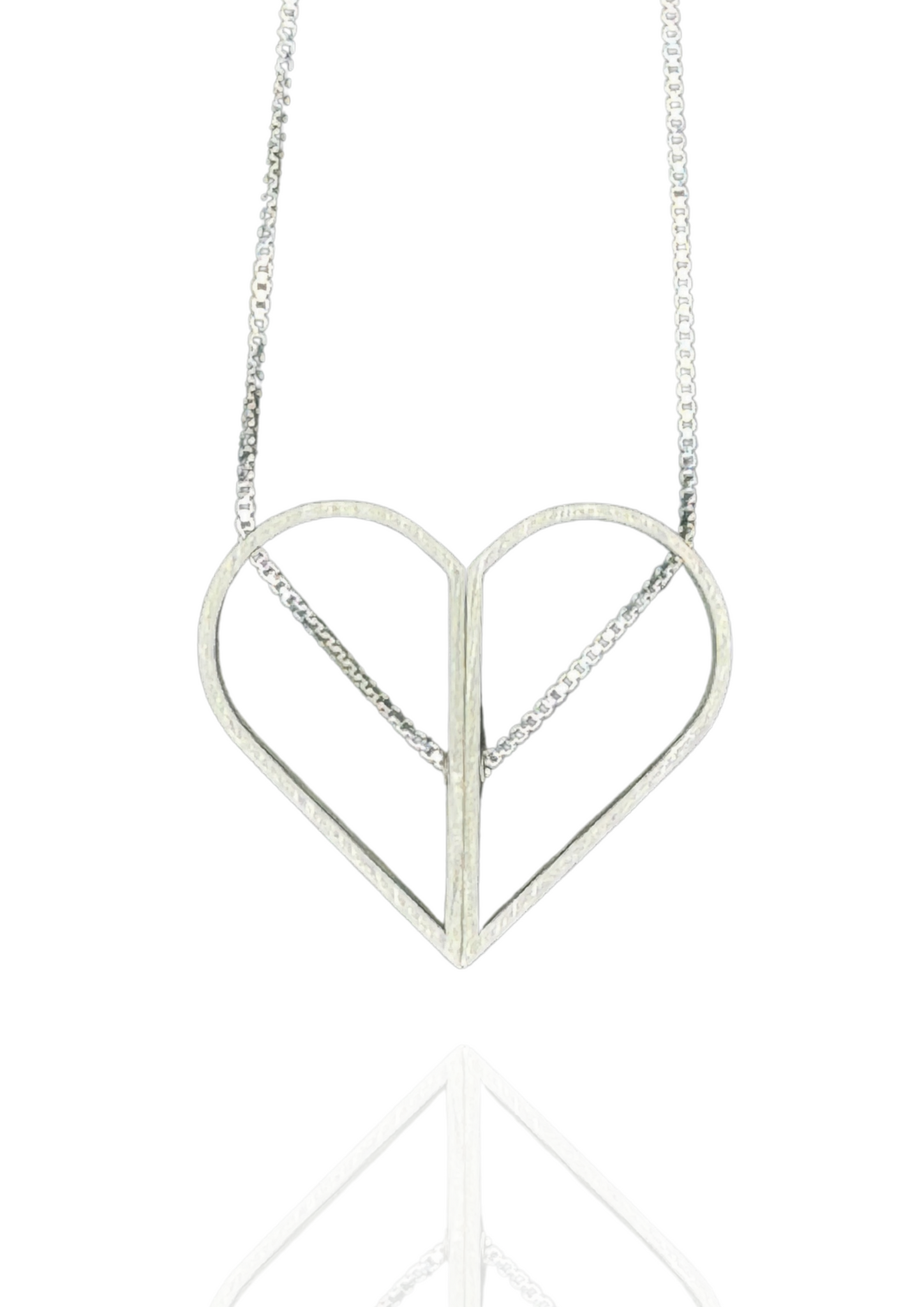 Minimalist sterling silver necklace with two spinning halves that form a full heart or an oval. Architectural and kinetic, with the chain threaded right through.