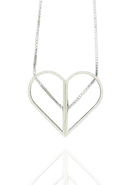 Minimalist sterling silver necklace with two spinning halves that form a full heart or an oval. Architectural and kinetic, with the chain threaded right through.