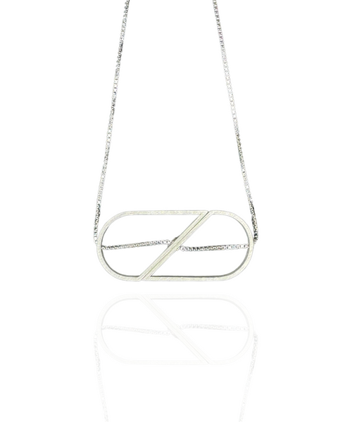 Minimalist sterling silver necklace with two spinning halves that form a full heart or an oval. Architectural and kinetic, with the chain threaded right through.