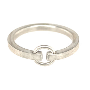 Sterling silver ring with brushed finish. The shank is made out of square wire, rounded on the inside for comfort. The shank doesn't fully connect on the top part, leaving a gap that is connected by a small circle.